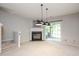 Comfortable living space features a fireplace, sliding glass doors, and neutral tones for versatile decor at 7616 Satinwing Ln, Raleigh, NC 27617