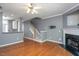 Spacious living room with hardwood floors, fireplace, and staircase access at 7616 Satinwing Ln, Raleigh, NC 27617