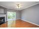 Bright living room with fireplace and sliding glass doors leading to the deck at 7616 Satinwing Ln, Raleigh, NC 27617