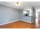 Open-concept living room with hardwood floors, natural light, and seamless flow to kitchen at 7616 Satinwing Ln, Raleigh, NC 27617