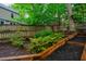 Backyard featuring raised garden beds and well-maintained plants against a backdrop of greenery at 8 Wexford Dr, Durham, NC 27713
