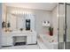 Bathroom featuring double sink vanity with a large mirror, bathtub, and glass shower at 8 Wexford Dr, Durham, NC 27713