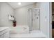 Bright bathroom featuring a white bathtub with jets and a glass shower with a showerhead at 8 Wexford Dr, Durham, NC 27713