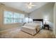Bedroom with neutral tones, carpeted floors, double windows, and a ceiling fan at 8 Wexford Dr, Durham, NC 27713