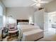 Bedroom with neutral tones, carpeted floors, ceiling fan and access to the ensuite bathroom at 8 Wexford Dr, Durham, NC 27713