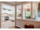 Sunlit kitchen featuring white cabinetry, granite counters, stainless appliances, and an eat-in dining area at 8 Wexford Dr, Durham, NC 27713