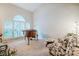 Bright living room featuring a piano and comfortable seating beneath a vaulted ceiling at 8 Wexford Dr, Durham, NC 27713