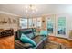 Inviting living room with leather sofa, area rug, and view of the kitchen and backyard at 8 Wexford Dr, Durham, NC 27713