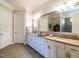 Bathroom featuring double sinks, lots of cabinet space, and a tiled floor at 8461 Lentic Ct, Raleigh, NC 27615