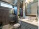 Bathroom featuring a tiled shower with a glass door and a white vanity at 8461 Lentic Ct, Raleigh, NC 27615
