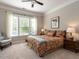 Cozy bedroom with a ceiling fan and a window with natural light at 8461 Lentic Ct, Raleigh, NC 27615