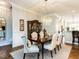 Formal dining space with elegant chandelier, hardwood floors, and classic decor at 8461 Lentic Ct, Raleigh, NC 27615
