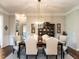 Inviting dining room with chandelier, traditional furniture, and hardwood floors at 8461 Lentic Ct, Raleigh, NC 27615