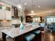 Open concept kitchen with granite counters, stainless steel appliances, and an eat-in island at 8461 Lentic Ct, Raleigh, NC 27615