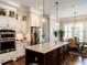 Spacious kitchen with granite counters, custom cabinets, and stainless steel appliances at 8461 Lentic Ct, Raleigh, NC 27615
