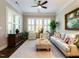 Relaxing living room with plantation shutters, a ceiling fan, and comfortable furniture at 8461 Lentic Ct, Raleigh, NC 27615