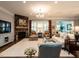 Bright living room featuring a stone fireplace, hardwood floors, and large windows at 8461 Lentic Ct, Raleigh, NC 27615