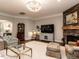 Open living room featuring a stone fireplace, decorative chandelier, and comfortable seating at 8461 Lentic Ct, Raleigh, NC 27615
