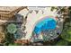 Aerial view of a backyard features a beautiful pool, patio furniture, and lush landscaping at 8724 Deerland Grove Dr, Raleigh, NC 27615