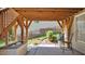 Relaxing covered outdoor patio features patio seating, garden bed, and a landscaped backyard at 8724 Deerland Grove Dr, Raleigh, NC 27615