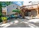 Backyard patio area with lounge chairs, dining set, and lush landscaping at 8724 Deerland Grove Dr, Raleigh, NC 27615