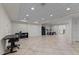 Large finished basement with tile flooring, recreational area and ample lighting at 8724 Deerland Grove Dr, Raleigh, NC 27615