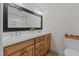 Well-lit bathroom features a double sink vanity with abundant cabinet space and a large framed mirror at 8724 Deerland Grove Dr, Raleigh, NC 27615