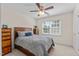 Cozy bedroom with a ceiling fan, large window and classic furniture at 8724 Deerland Grove Dr, Raleigh, NC 27615