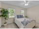 Comfortable bedroom with a cozy bed, neutral colors and natural lighting at 8724 Deerland Grove Dr, Raleigh, NC 27615