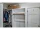 Organized walk-in closet with shelves and hanging space for clothes and storage boxes at 8724 Deerland Grove Dr, Raleigh, NC 27615