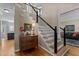 Elegant entryway with hardwood floors, staircase, and stylish decor, creating a warm welcome at 8724 Deerland Grove Dr, Raleigh, NC 27615