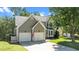 Charming two-story home with a two-car garage, well-manicured lawn, and traditional design at 8724 Deerland Grove Dr, Raleigh, NC 27615