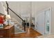 Spacious foyer with hardwood floors, a staircase with contrasting banister, and a bright, inviting entrance at 8724 Deerland Grove Dr, Raleigh, NC 27615