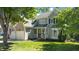 Charming two-story home with a well-manicured lawn, two car garage, and inviting front porch at 8724 Deerland Grove Dr, Raleigh, NC 27615