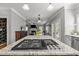 Open concept kitchen with granite island cooktop, stainless steel appliances, with view to the living and dining rooms at 8724 Deerland Grove Dr, Raleigh, NC 27615