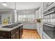 Modern kitchen featuring granite countertops, white cabinets, and stainless-steel appliances, with lots of counter space at 8724 Deerland Grove Dr, Raleigh, NC 27615