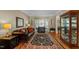 Comfortable living room with hardwood floors, leather seating, and a bay window at 8724 Deerland Grove Dr, Raleigh, NC 27615