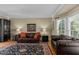 Cozy living room featuring leather sofas, accent lighting, and a decorative rug at 8724 Deerland Grove Dr, Raleigh, NC 27615