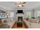 Bright living room featuring a fireplace, ceiling fan and two couches perfect for Gathering time at 8724 Deerland Grove Dr, Raleigh, NC 27615