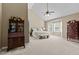 Spacious main bedroom with vaulted ceilings, sitting area, carpet, and two dressers at 8724 Deerland Grove Dr, Raleigh, NC 27615