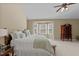 Comfortable main bedroom with a bay window, a ceiling fan, and carpet at 8724 Deerland Grove Dr, Raleigh, NC 27615