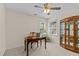 Home office area with a wooden desk, cabinet and bright natural light from two windows at 8724 Deerland Grove Dr, Raleigh, NC 27615