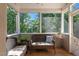 Cozy screened-in porch with natural light and wicker furniture at 8724 Deerland Grove Dr, Raleigh, NC 27615