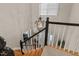 View of stairway featuring a decorative chandelier, wood stairs, and neutral colored walls at 8724 Deerland Grove Dr, Raleigh, NC 27615