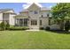 Expansive backyard featuring lush green lawn and a screened-in porch, great for outdoor living at 937 Sedgefield Park Ln, Cary, NC 27519