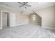 Spacious bedroom with neutral walls, soft carpet, ceiling fan, and natural light from the window at 937 Sedgefield Park Ln, Cary, NC 27519