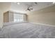 Expansive carpeted bonus room with built-in shelves, recessed lighting, and a ceiling fan at 937 Sedgefield Park Ln, Cary, NC 27519