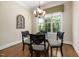 Cozy breakfast nook with a glass-top table, comfortable seating, and bright natural light from large windows at 937 Sedgefield Park Ln, Cary, NC 27519