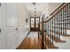 Elegant foyer with hardwood floors, a staircase, and double front doors at 937 Sedgefield Park Ln, Cary, NC 27519
