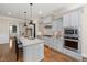 Well-equipped kitchen with center island, stainless steel appliances, and stylish backsplash, designed for modern living at 937 Sedgefield Park Ln, Cary, NC 27519